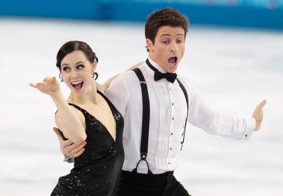 Tessa Virtue and Scott Moir of Canada compete in the team ice dance short dance figure skating competition. (Ivan Sekretarev/AP Photo).