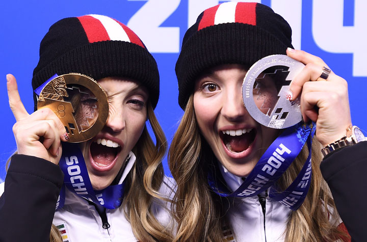 Canadian sisters Justine Dufour-Lapointe, left, and Chloe Dufour-Lapointe, right, show off their gold and silver medals from women's freestyle moguls after the medal ceremony. 