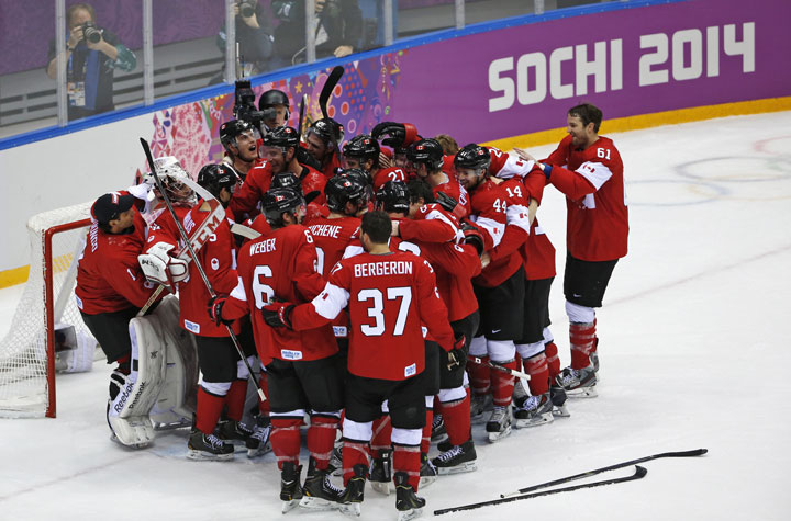 Team Canada celebrates their 3-0 win over Sweden in the men's gold medal ice hockey game.