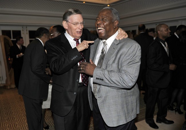 Baseball Hall of Famer Hank Aaron, right, laughs as he talks with baseball Commissioner Bud Selig, left, at a reception for Aaron, Friday, Feb. 7, 2014, in Washington. (AP Photo/Nick Wass)