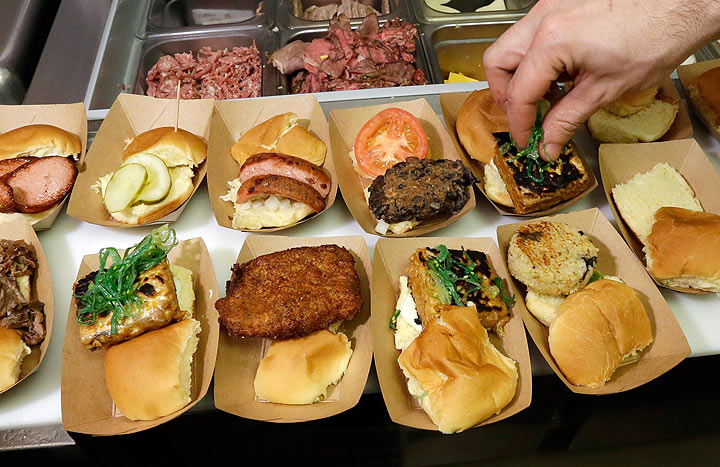 In a Jan. 28, 2014 photo in Detroit, sliders are prepared at the Green Dot Stables, a bustling sliders joint in an industrial area not far from downtown. The restaurant may restore your faith in the city's future and will give you a whole new vision of the lowly slider.