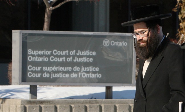 Lev Tahor community spokesman Uriel Goldman walks to the courthouse for the child custody case decision in Chatham, Ont. Monday, Feb. 3, 2014.