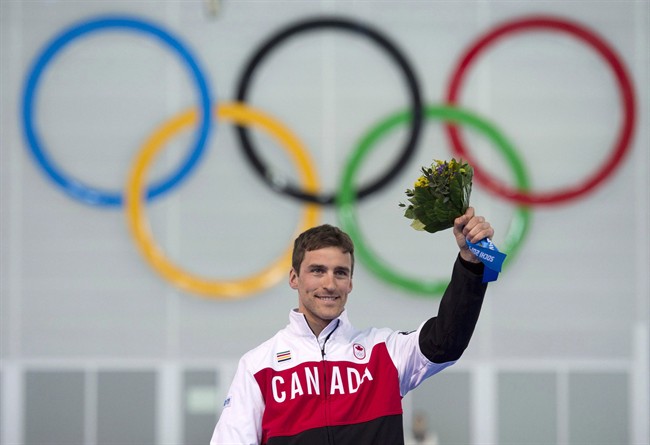 Canada's Denny Morrison stands on the podium Saturday February 15, 2014 in Sochi, Russia.