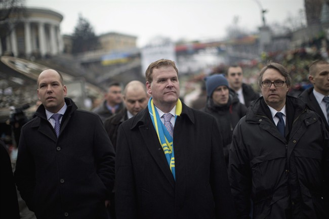 Canada's Minister of Foreign Affairs John Baird, centre, walks in Kyiv's Independence Square, Friday, Feb. 28, 2014.