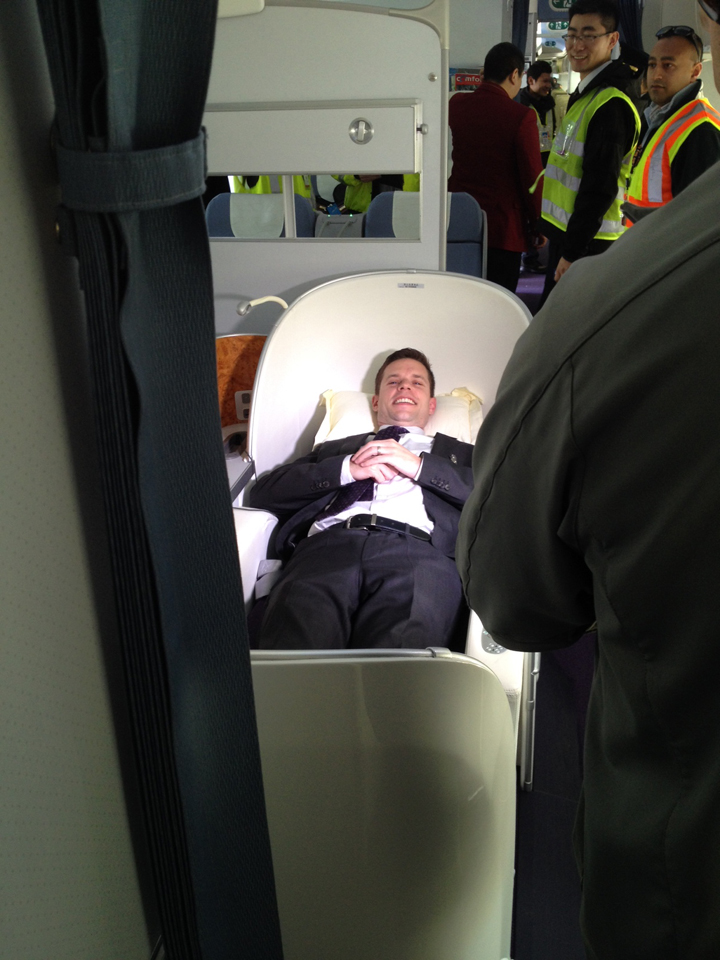 Reporter Geoff Hastings takes advantage of the ‘seat / bed’ on board.