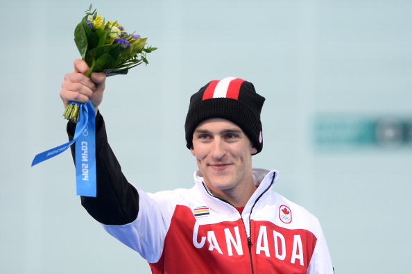 Canada’s Denny Morrison, silver medallist, celebrates on the podium during the Men’s Speed Skating 1000 m Flower Ceremony at the Adler Arena at the Sochi Winter Olympics on February 12, 2014.