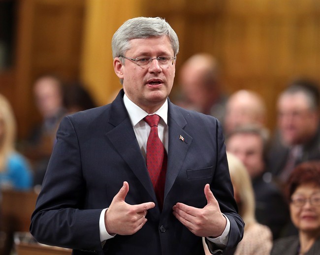 Prime Minister Stephen Harper stands in the House of Commons during question period, in Ottawa Tuesday, February 11, 2014. 