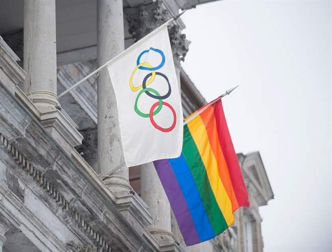 The rainbow flag flies over city hall alongside the Olympic flag in Montreal on Feb. 7, 2014.