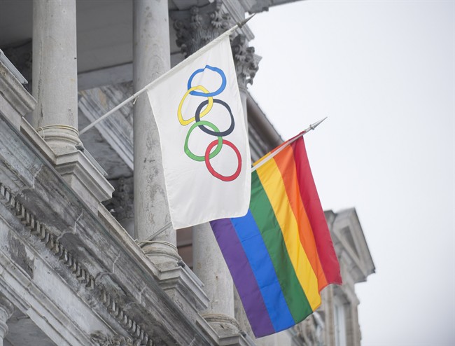 The rainbow flag flies over city hall alongside the Olympic flag in Montreal on Feb. 7, 2014.