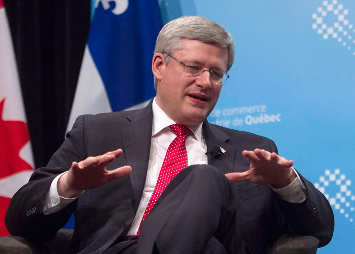 Prime Minister Stephen Harper gestures during an appearance at the Quebec Chamber of Commerce in Quebec City, Thursday, Feb.6, 2014. 