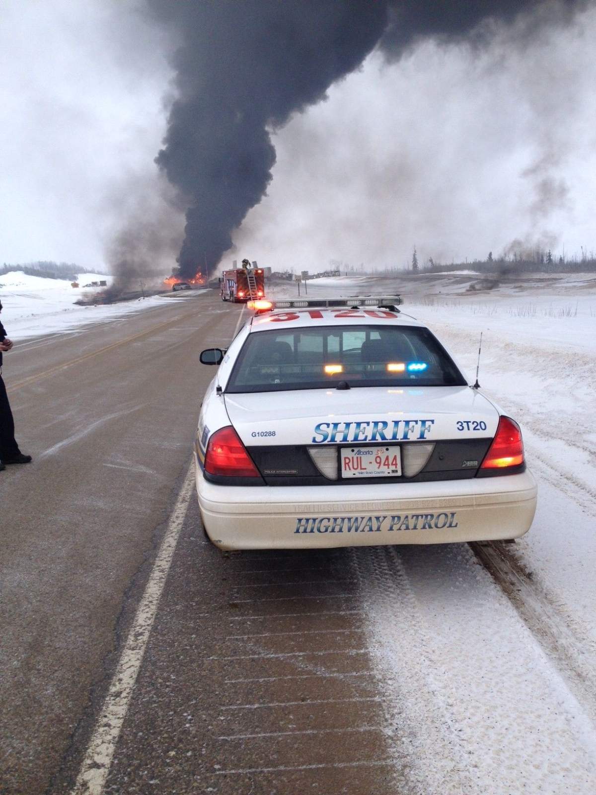 An RCMP cruiser is parked near a crash on Highway 63 that claimed the life of two men, Wednesday, February 19, 2014.