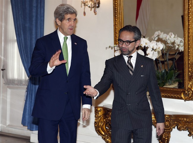 U.S. Secretary of State John Kerry, left, is ushered by Indonesian Foreign Minister Marty Natalegawa before a meeting at the Foreign Ministry office in Jakarta, Indonesia, Monday, Feb. 17, 2014. 