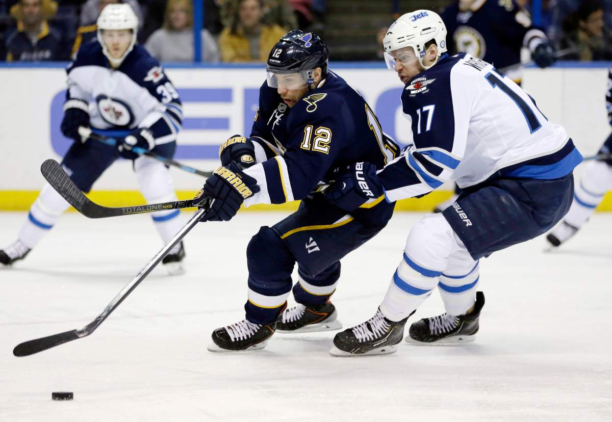 St. Louis Blues' Derek Roy, left, and Winnipeg Jets' James Wright chase after a loose puck during the second period of an NHL hockey game Saturday, Feb. 8, 2014, in St. Louis. 