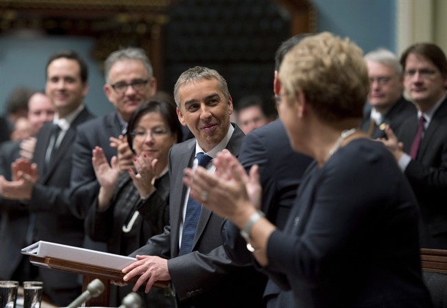 Quebec Finance Minister Nicolas Marceau is applauded by members of the government as he stands to present his budget speech, Thursday, February 20, 2014 at the legislature in Quebec City. 