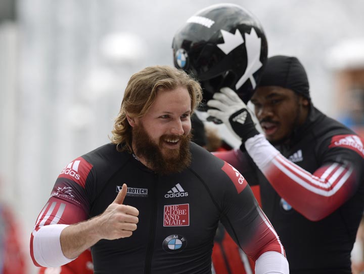 Canadian Justin Kripps and Bryan Barnett celebrate after the two-man Bob World Cup final competition race in Schoenau near Koenigssee, southern Germany, on January 25, 2014. 