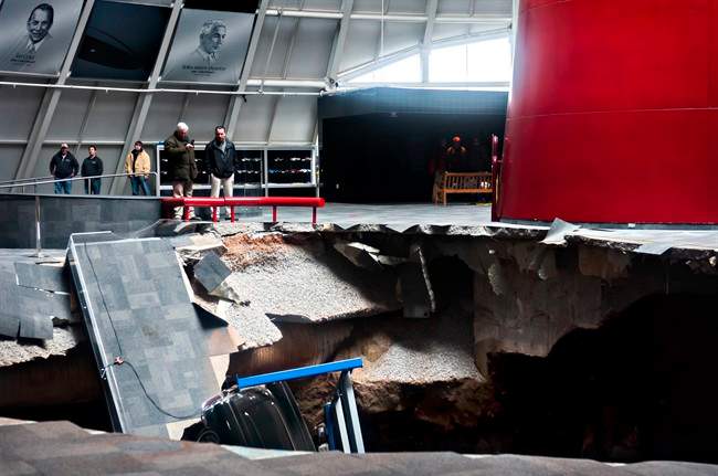 Officials view a sinkhole that opened up in the Skydome showroom, Wednesday, Feb. 12, 2014, at the National Corvette Museum in Bowling Green, Ky. 