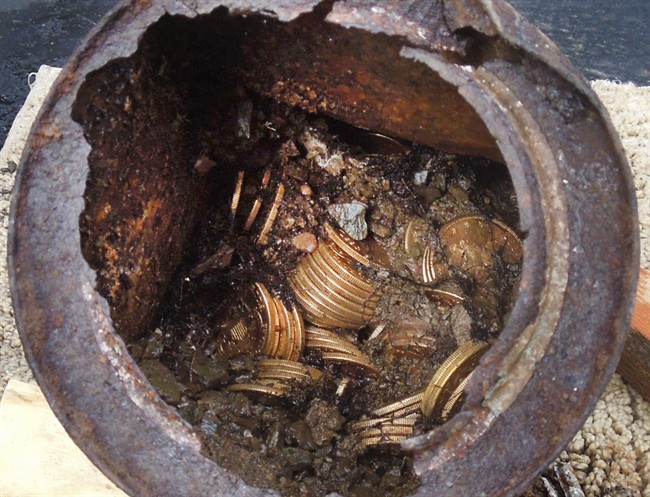 This image provided by the Saddle Ridge Hoard discoverers via Kagin's, Inc., shows one of the six decaying metal canisters filled with 1800s-era U.S. gold coins unearthed in California by two people who want to remain anonymous. 