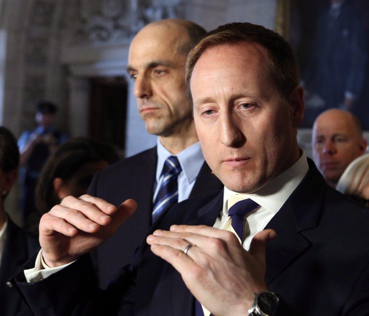 Justice Minister Peter MacKay (right) talks to reporters as Public Safety Minister Steven Blaney looks on in Ottawa, on Wednesday February 26, 2014. THE CANADIAN PRESS/Fred Chartrand.