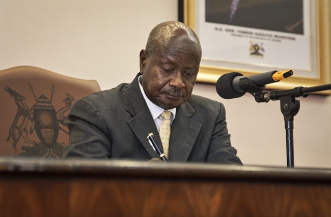 Uganda's President Yoweri Museveni signs a new anti-gay bill that sets harsh penalties for homosexual sex, in Entebbe, Uganda Monday, Feb. 24, 2014.