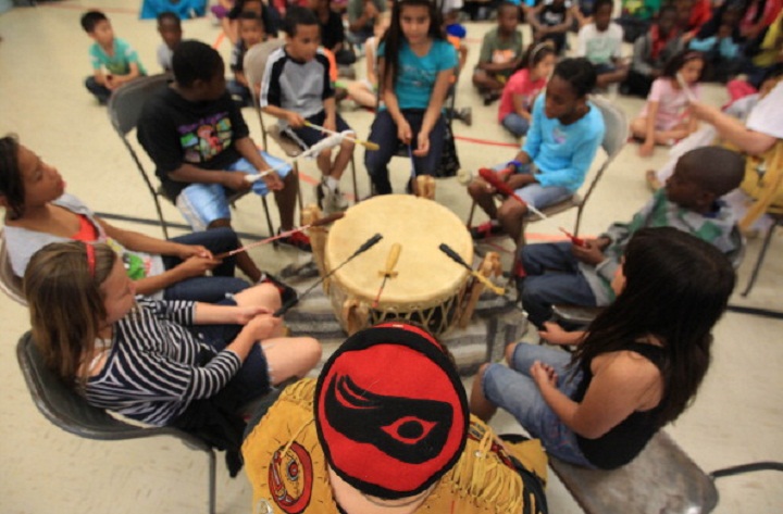 Kate Dickson (Thunderbird's sister) leads a group of students on the 'All one People' drum. Lead by artist and activist Shannon Thunderbird the children of Bala Community School learn about aboriginal culture, including pow-wow drums.