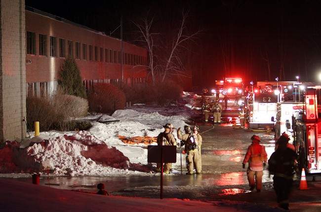 Emergency crews from several towns work an area outside the New Hampshire Ball Bearing plant after an explosion, Monday, Feb. 10, 2014 in Peterborough, N.H.