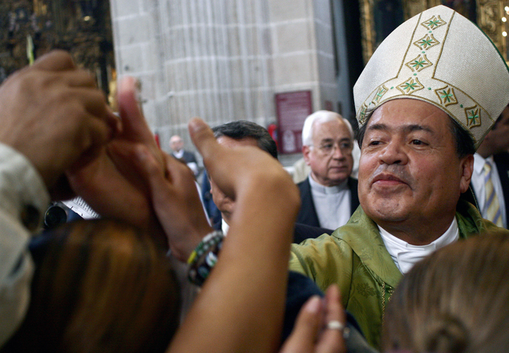 Mexican cardinal Norberto Rivera greets the faithful, during mass at the metropolitan cathedral in Mexico City, on October 7th, 2007, as  protestors (out of frame) wait outside the church. 