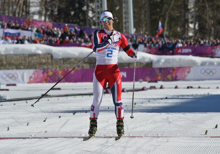 Norway's Marit Bjoergen celebrates winning the Women's Cross-Country Skiing 7,5km + 7,5km Skiathlon at the Laura Cross-Country Ski and Biathlon Center during the Sochi Winter Olympics on February 8, 2014 in Rosa Khutor.   