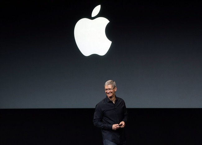In this Tuesday, Sept. 10, 2013, file photo, Apple CEO Tim Cook speaks on stage before a new product introduction in Cupertino, Calif. 