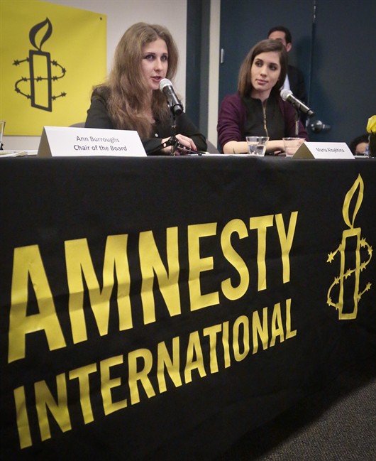 Members of the punk band Pussy Riot, Maria “Masha” Alyokhina, left, and Nadezhda “Nadya” Tolokonnikova, right, hold a news conference at Amnesty International's New York headquarters, on Tuesday Feb. 4, 2014 in New York. They were released from Russian prison in December, after nearly two years in jail following a conviction for hooliganism when they staged a protest in a Russian church, in what was widely seen as a public relations move ahead of the Olympics by Russian President Vladimir Putin.