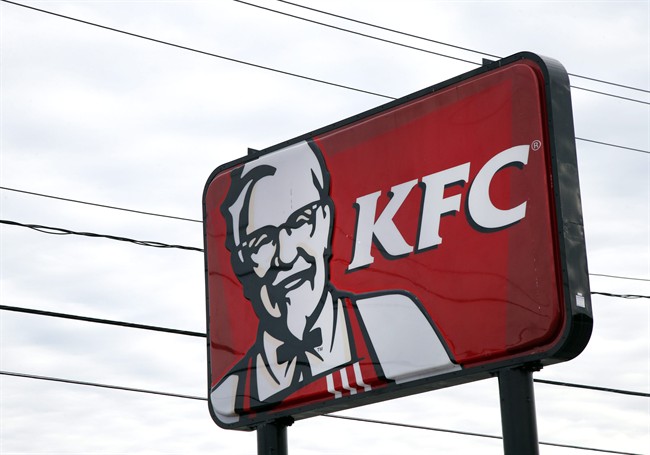 In this Friday, Jan. 31, 2014, photo, a KFC sign hangs in Saugus, Mass. 