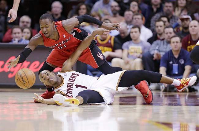 Cleveland Cavaliers' Jarrett Jack (1) and Toronto Raptors' Terrence Ross (31) battle for a loose ball during the second quarter of an NBA basketball game, Tuesday, Feb. 25, 2014, in Cleveland.