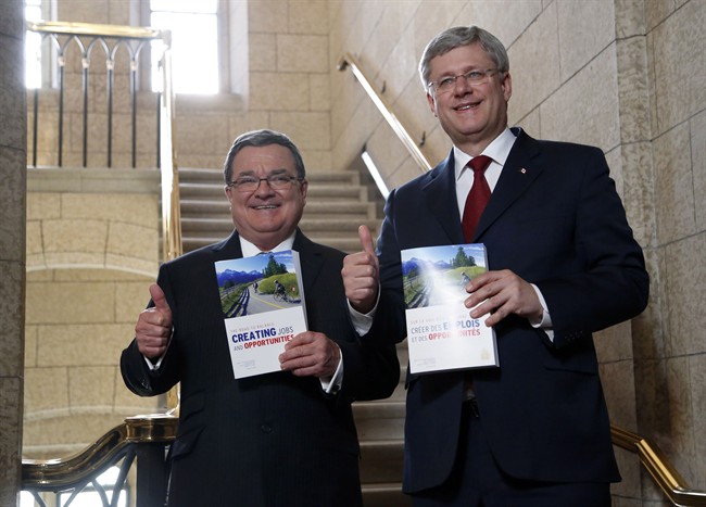 Minister of Finance Jim Flaherty and Prime Minister Stephen Harper enter the House of Commons on budget day on Parliament Hill in Ottawa on Tuesday, February 11, 2014.