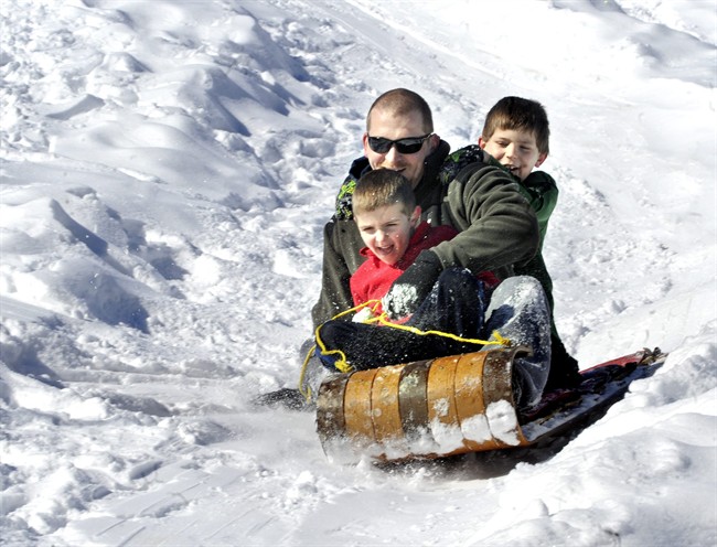 Josh Davis, Bloomsburg, Pa., and his sons Kaden, front, 5, and Cole, 8, ride a toboggan downhill at Josh’s cousin Barry J. Davis’ home near Bloomsburg, Pa., on Monday, Feb. 17, 2014. Josh and Barry constructed the downhill toboggan run for their boys to enjoy on the Presidents Day holiday. (AP Photo/Bloomsburg Press Enterprise, Bill Hughes).