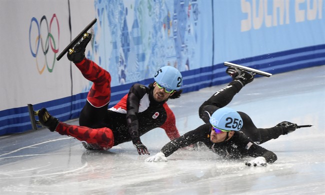 Canada’s Charles Hamelin crashes with Eduardo Alvarez, of the United States, during the men’s 1,000 metre quarter-finals. THE CANADIAN PRESS/Paul Chiasson