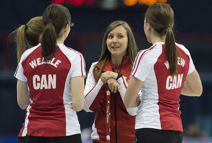 Team Canada skip Rachel Homan chats with teammates, from left, Alison Kreviazuk, Lisa Weagle and Emma Miskew while taking a break during their draw against team Ontario at the Scotties Tournament of Hearts in Montreal on Sunday.