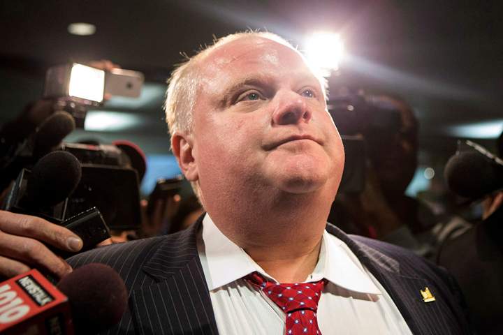 Toronto Mayor Rob Ford is questioned by reporters as he returns to the council floor at city hall in Toronto on Thursday, January 30, 2014.