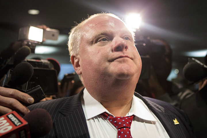 Toronto Mayor Rob Ford is questioned by reporters as he returns to the council floor at city hall in Toronto on Thursday, January 30, 2014.