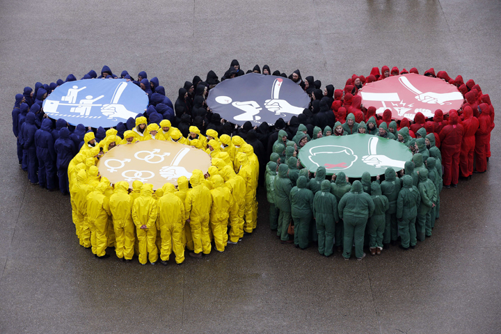 Activists of various NGOs gather to form the Olympics rings to protest against human rights violations in Russia ahead of the Sochi Winter Olympics, on February 1, 2014, in Paris.