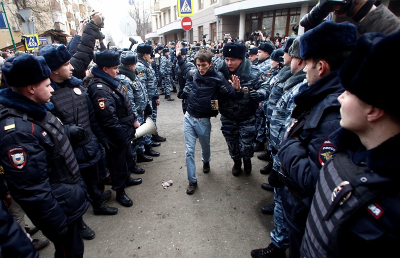 Police detain people outside Zamoskvoretsky District Court in Moscow, Russia, Friday, Feb. 21, 2014. The court on Friday is to deliver a verdict in the trial of eight defendants facing charges for their role in a protest in Moscow on May 6 2012 that ended in violent clashes with police. 