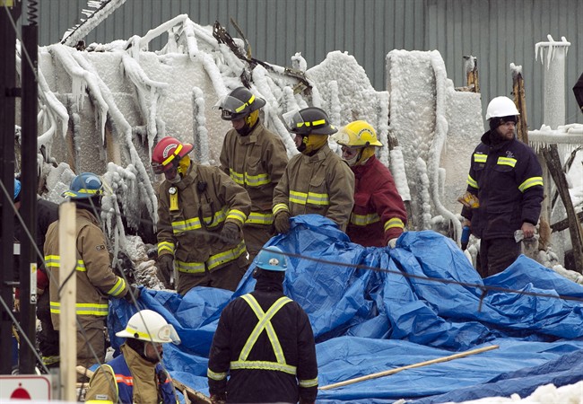 Firefighters work at the scene of a fatal fire at a seniors residence in L'Isle-Verte, Que., Thursday, January 23, 2014.
