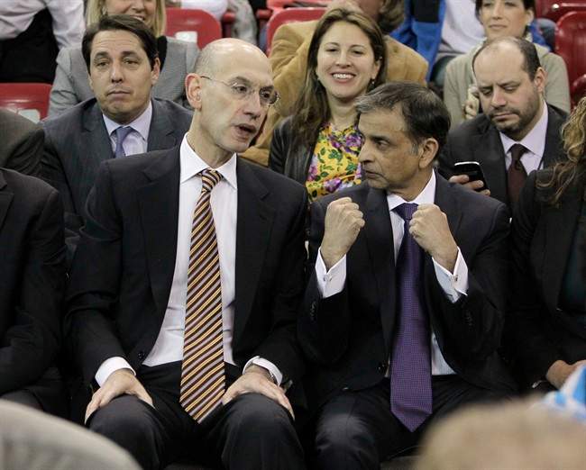Adam Silver, the new NBA Commissioner, talks with Sacramento Kings majority owner Vivek Ranadive as the Kings play the Toronto Raptors during the first quarter of an NBA basketball game in Sacramento, Calif., Wednesday, Feb. 5, 2014. Silver replaced David Stern Feb. 1, who retired after 30 years as the head of the NBA.