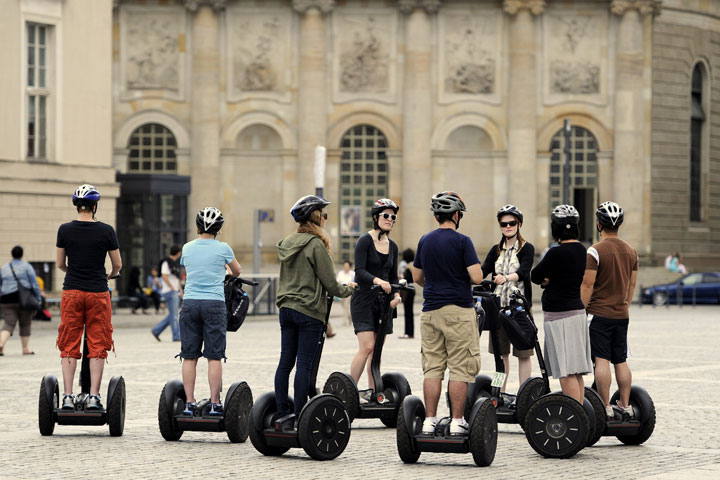 A group of tourists stops at Bebelplatz while on a guided 'Segway'-tour of Berlin on July 30, 2010. 