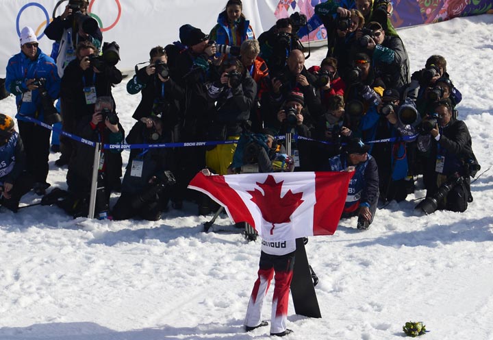 Silver Medallist, Canada's Dominique Maltais celebrates during the Women's Snowboard Cross Flower Ceremony at the Rosa Khutor Extreme Park during the Sochi Winter Olympics on February 16, 2014.   
