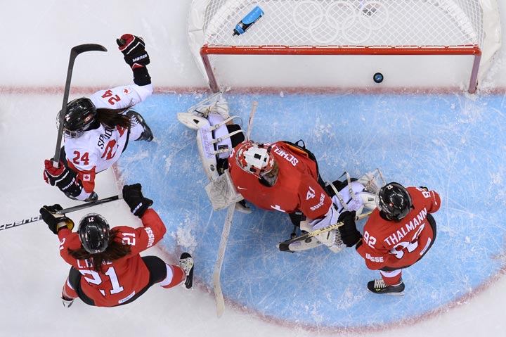 Canada's Natalie Spooner (L) celebrates after scoring during the Women's Ice Hockey Play-offs Semifinals match Canada vs Switzerland at the Shayba Arena during the Sochi Winter Olympics on February 17, 2014.  