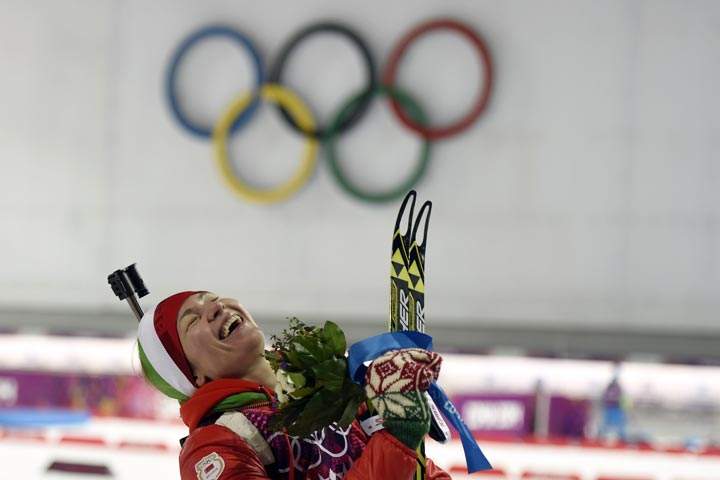 Gold medalist Belarus’ Darya Domracheva celebrate on the podium in the Women’s Biathlon 12,5 km Mass Start at the Laura Cross-Country Ski and Biathlon Center during the Sochi Winter Olympics on February 17, 2014, in Rosa Kuthor, near Sochi. (Odd Andersen/AFP/Getty Images)