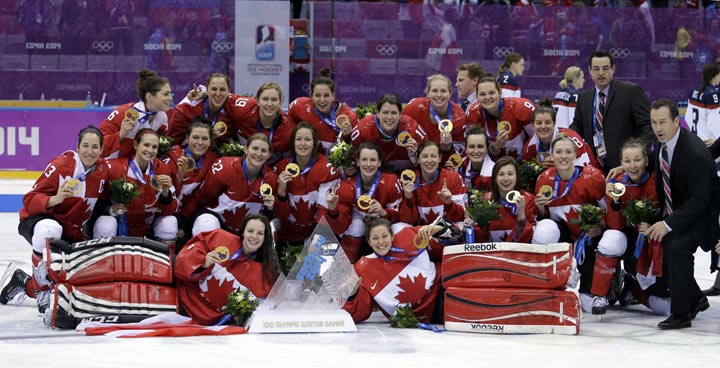 Team Canada gathers for a group photo after beating the USA 3-2 in overtime of the gold medal women's ice hockey game at the 2014 Winter Olympics, Wednesday, Feb. 19, 2014, in Sochi, Russia. (AP Photo/David Goldman)
.