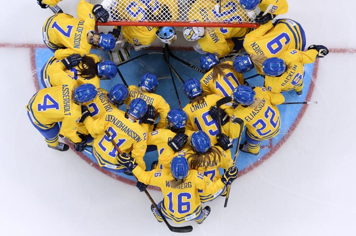 Sweden’s players gather before the start of the Women’s Ice Hockey Group B match Sweden vs Japan at the Shayba Arena during the Sochi Winter Olympics on February 9, 2014. (Andrej Isakovic/AFP/Getty Images)