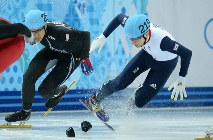 Great Britain’s Jack Whelbourne (R) falls as he competes in the Men’s Short Track 1500m Final at the Iceberg Skating Palace during the Sochi Winter Olympics on February 10, 2014. (Jung Yeon-Je/AFP/Getty Images)
