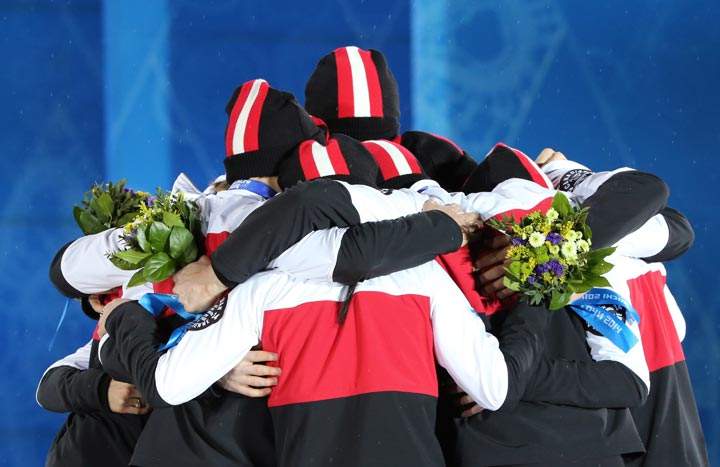 Members of Canada silver medalist team celebrate on the podium during the Figure Skating Team Medal Ceremony at the Sochi medals plaza during the Sochi Winter Olympics on February 10, 2014. (Loic Venance/AFP/Getty Images)