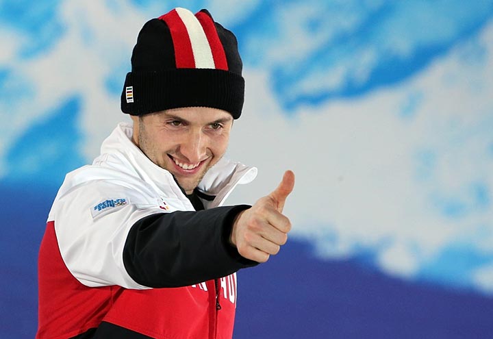 Canada’s gold medalist Alex Bilodeau celebrates on the podium during the Men’s Freestyle Skiing Moguls Medal Ceremony at the Sochi medals plaza during the Sochi Winter Olympics on February 11, 2014.